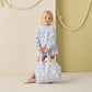 A young girl holds the Rylee & Cru Terry Beach Bag, standing indoors against a beige and olive green wall with rope decor.