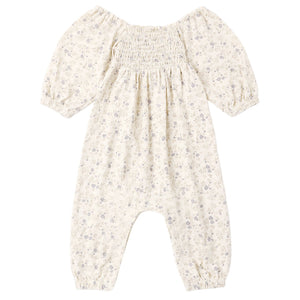 The Rylee & Cru Baby Girls’ Sage Jumpsuit features elastic long sleeves, a smocked bodice, elastic cuffs, and a delicate floral pattern in soft gray and lavender tones. The garment is displayed laid flat on a white background.