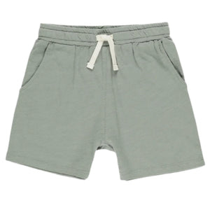 The Boys' Sam Short by Rylee & Cru in a light eucalyptus hue features airy cotton, an elastic waistband, and two side pockets, shown on a white background.
