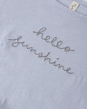 The Rylee & Cru Girls' Cropped Cinch Tee features a light blue color, cinched fit, and "hello sunshine" embroidered in gray cursive for a relaxed, cheerful look.