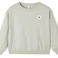 Rylee & Cru Baby Girls’ and Girls’ Oversized Sweatshirt in light gray, featuring long sleeves and a small embroidered white daisy with a brown center on the upper left chest.