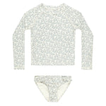 The Rylee & Cru Baby Girls' and Girl's Maryn Rashguard Set is a two-piece swim set with a white and blue floral design, UPF 50+ sun protection, including a long-sleeve top and bikini bottoms—perfect for safe fun at the beach or pool.