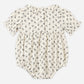 The Rylee & Cru Baby Girls’ Liv Romper is a vintage-inspired bubble romper featuring short puffed sleeves, a ruffled scalloped collar, and a black floral pattern on white fabric, with three buttons visible on the back.