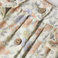 Close-up of the Rylee & Cru Baby Girls' Maya Romper: pastel floral fabric with pleats and round wooden buttons—perfect for a vintage summer look.