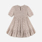 A Girls’ India Dress by Rylee & Cru, featuring short sleeves, a knee-length floral design, a smocked bodice, gathered skirt, and back button closure, is displayed flat on a white background.