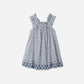 The Girls' Lennon Dress by Rylee & Cru is a sleeveless blue and white gingham mini dress with a ruffled neckline and blue floral embroidery along the scalloped eyelet hem.