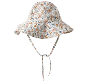 The Girls' Floppy Swim Hat by Rylee & Cru features a wide brim, chin straps, and a floral print in orange, blue, and green on white. It offers UPF 50+ sun protection for stylish outdoor safety.