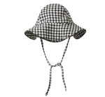 The Rylee & Cru Baby Swim Hat features a black and white checkered design with a wide brim and chin straps for stylish sun protection, shown against a white background.