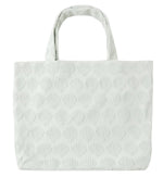 Light-colored Rylee & Cru Beach Bag with a textured scallop shell pattern and two handles, displayed against a white background—an ideal everyday accessory.