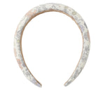 The Girls' Padded Headband from Rylee & Cru features a white fabric with a pastel floral and leaf pattern, making it the perfect playful summer accessory for any outfit.