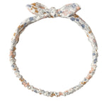 The Rylee & Cru Baby Bow Headband features a pastel floral print, a small top bow, and a comfy scrunchy elastic band at the back.
