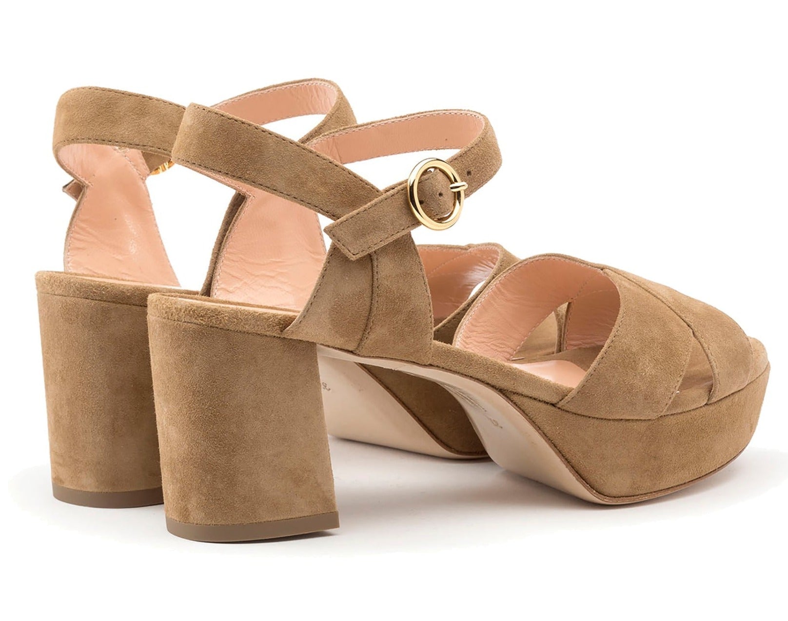 A pair of beige suede Rupert Sanderson Deidre Platform Sandals with chunky heels and crisscross straps, isolated on a white background.