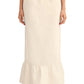 A person wears the POSSE Matilda Column Skirt—a premium linen, high-waisted skirt with a ruffled hem—paired with a white top and white shoes.