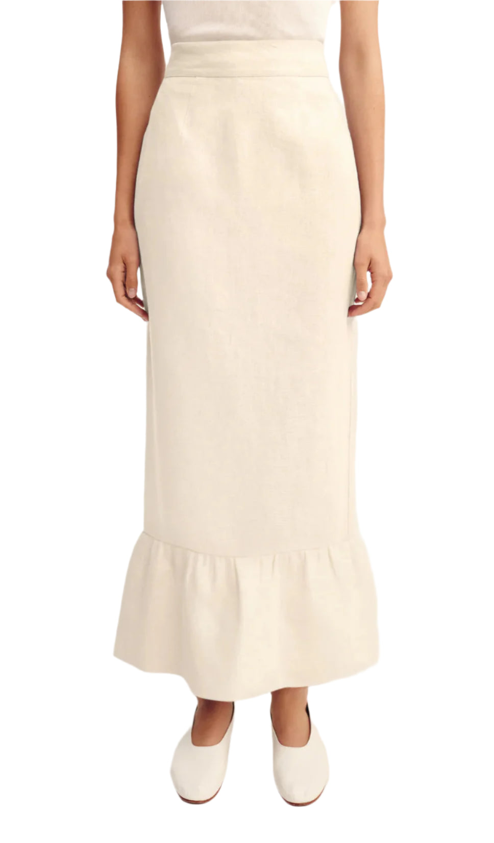 A person wears the POSSE Matilda Column Skirt—a premium linen, high-waisted skirt with a ruffled hem—paired with a white top and white shoes.