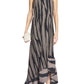A woman in Lanvin's Asymmetrical Cascade-Effect Dress, featuring a zebra print, one-shoulder neckline, ruffled hem, and integrated bustier, holds a small clutch and wears flat shoes.