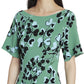A woman wearing the Lanvin Jacquard Midi Dress, adorned with black and white floral patterns, short sleeves, and a boat neckline, embodies the elegance of Lanvin's French designer style.