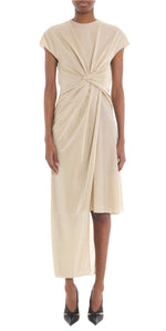 The person exudes sophistication in a chic ensemble featuring the Lanvin Asymmetrical Long Dress in beige, with beautifully draped detailing. The look is flawlessly completed with black pointed heels.