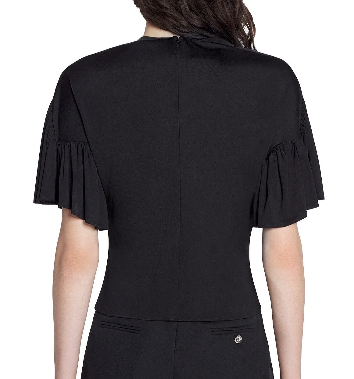 Rear view of a woman wearing a Lanvin Summer Top with Eyelet Detail, black blouse with short ruffled sleeves, and a zipper closure at the back.