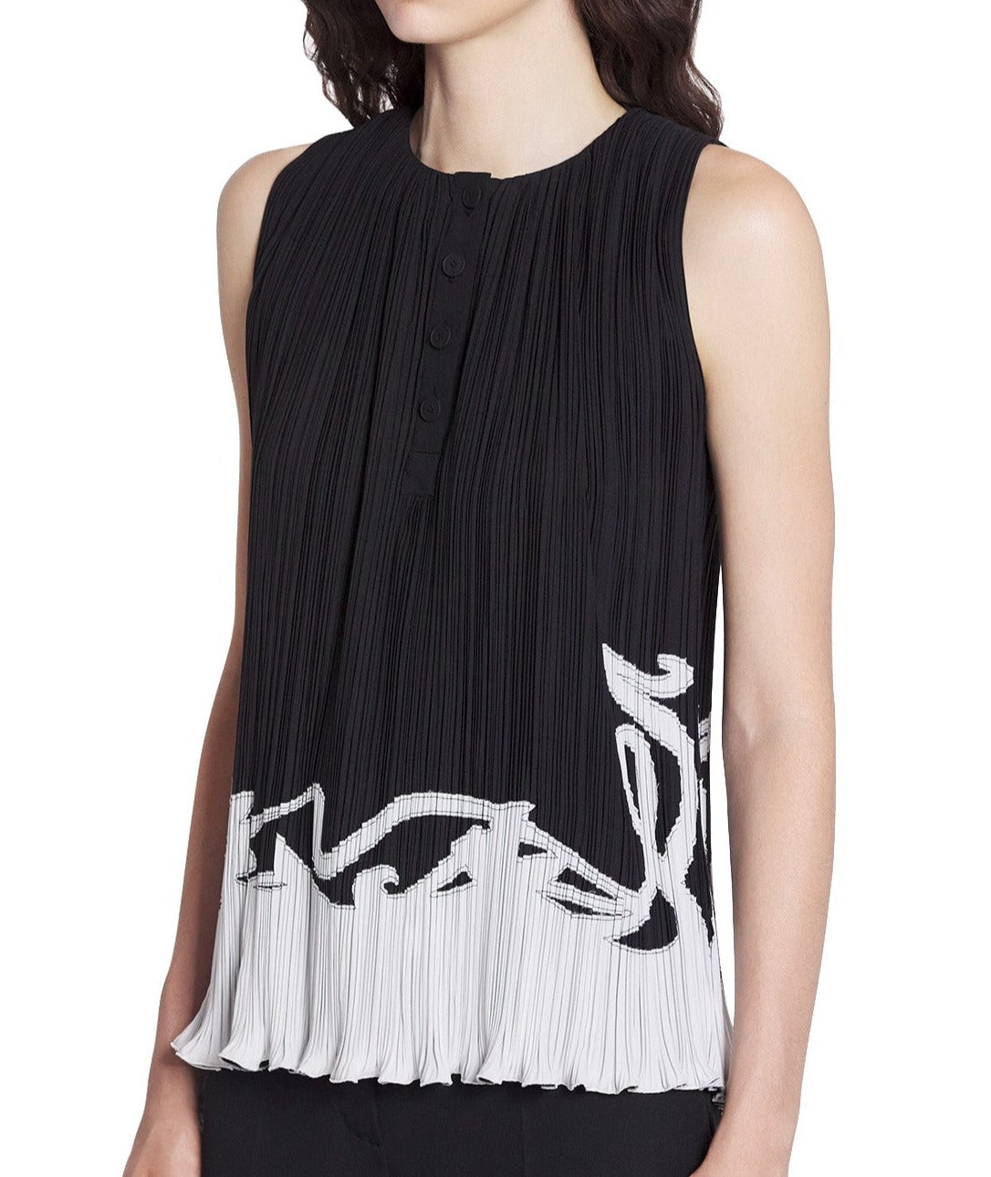 Woman wearing a Lanvin sleeveless pleated top made in Spain, with vertical pleats and a white abstract Art Nouveau design at the hem.