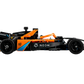 Side view of the LEGO® Technic™ Neom McLaren Formula E Race Car, featuring black and orange colors, sponsor logos, number 60, visible wheels, and detailed aerodynamic features.