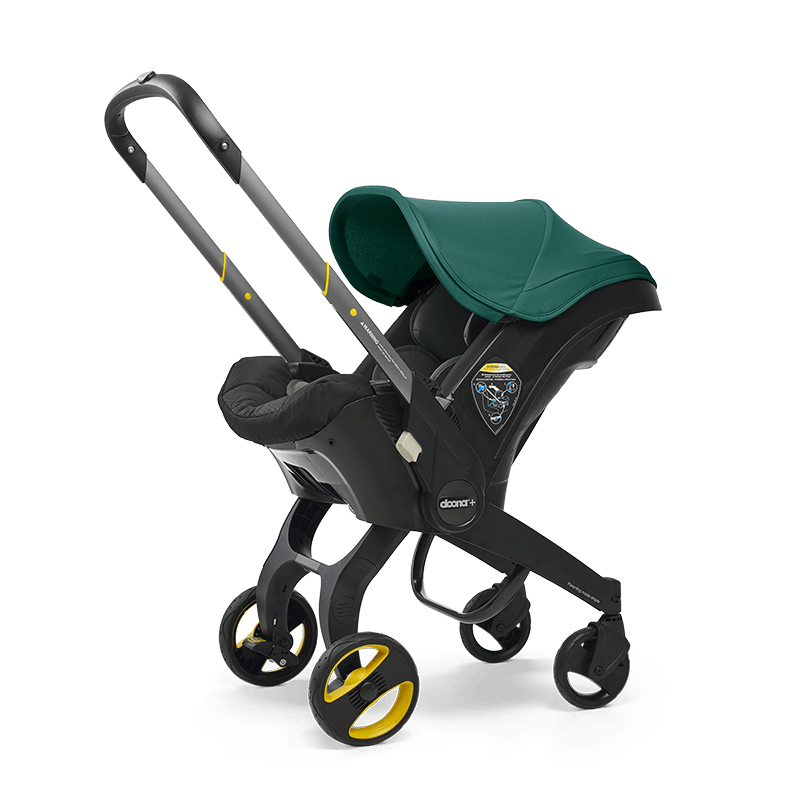 The Doona Car Seat and Stroller by Doona is a green and black infant car seat that easily converts into a travel system with an extended handle and four wheels, resembling a stroller.