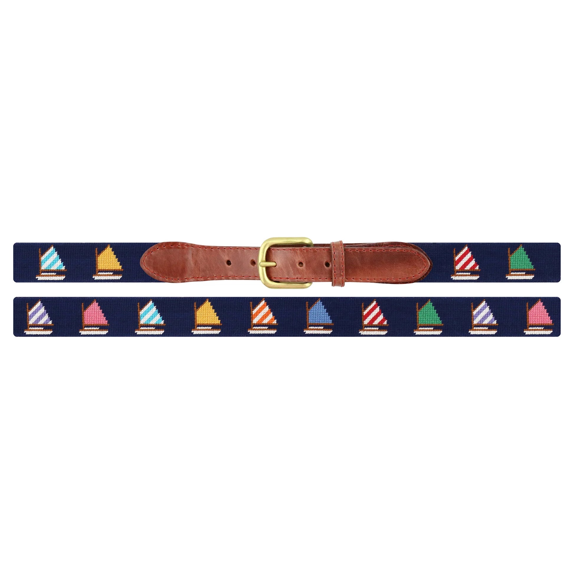 The Rainbow Fleet Belt by Smathers & Branson features a navy backdrop adorned with hand-stitched, colorful sailboats in a repeating needlepoint pattern, complemented by brown Italian leather accents and finished with a gold buckle.