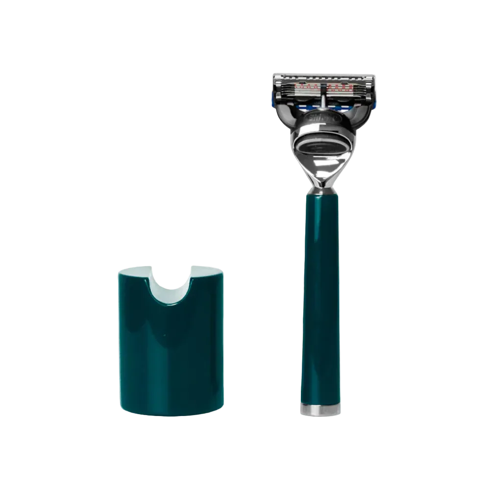 The Barberino's Ultimate 5 Blade Razor, featuring an ergonomic teal and silver handle, stands upright beside its matching teal holder against a white background.