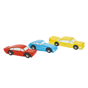 Three Retro Cars by Tender Leaf Toys—one red, one blue, and one yellow—are lined up side by side on a white background.
