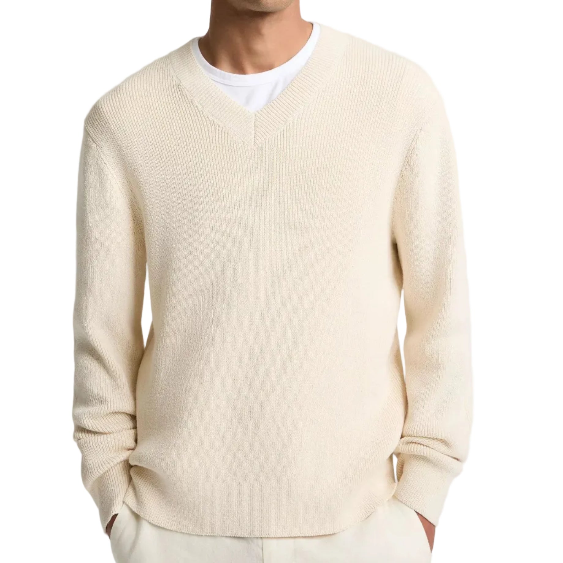 A man wearing the vince Spring Rib Longsleeve V Neck sweater in cream over a white T-shirt, with his hands in his pockets.