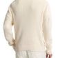 A person is seen from the back against a white background, wearing vince's Spring Rib Longsleeve V Neck in cream-colored Italian cotton and light pants.