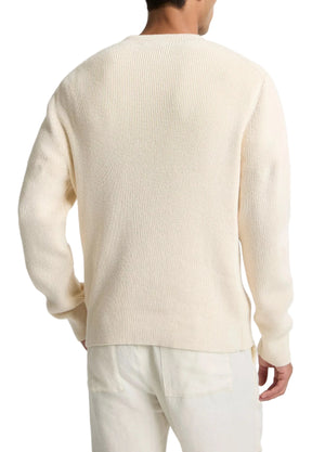 A person is seen from the back against a white background, wearing vince's Spring Rib Longsleeve V Neck in cream-colored Italian cotton and light pants.