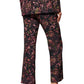 A person wearing the Figue Sioban Pant, featuring a matching polyester paisley floral print suit, viewed from the back, paired with open-toe high-heeled sandals.