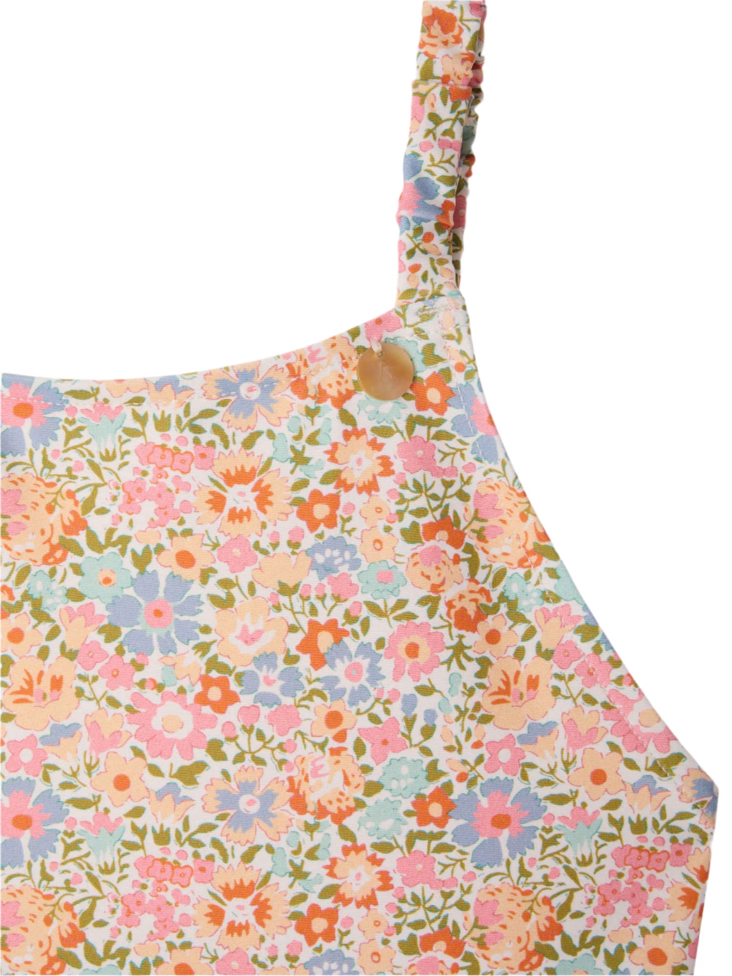 Close-up of the Bonpoint Girls' Emna Swimsuit One-Piece in Liberty Print, featuring a floral pattern in pink, blue, orange, and green with a thin shoulder strap and a small round button at the top.