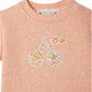 The Bonpoint Clelie t-shirt for baby girls features a cherry motif in Liberty Fabrics on organic cotton, with a peach hue and two shoulder buttons for easy dressing.