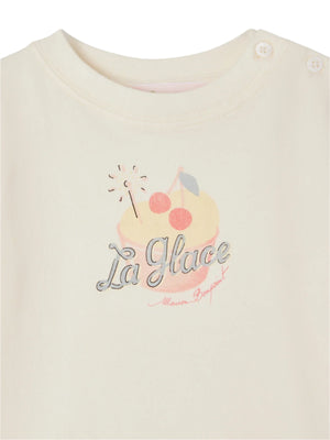 The Baby Girls' and Girls' Dom T-shirt by Bonpoint is a cream organic cotton tee featuring an ice cream sundae, two cherries, "La Glace" and "Maison Bonjouet" on the front, with two shoulder buttons.