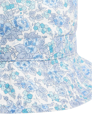 Close-up of the Bonpoint Piob Hat, made with Liberty fabric and featuring a blue and white floral print.
