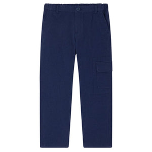 Bonpoint Boys' Francis Cargo Trousers in navy blue, made from soft organic cotton with an elastic waistband, side pockets, and a large flap pocket on the right leg. Pants are laid flat on a white background.