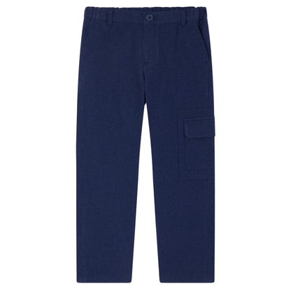 Bonpoint Boys' Francis Cargo Trousers in navy blue, made from soft organic cotton with an elastic waistband, side pockets, and a large flap pocket on the right leg. Pants are laid flat on a white background.