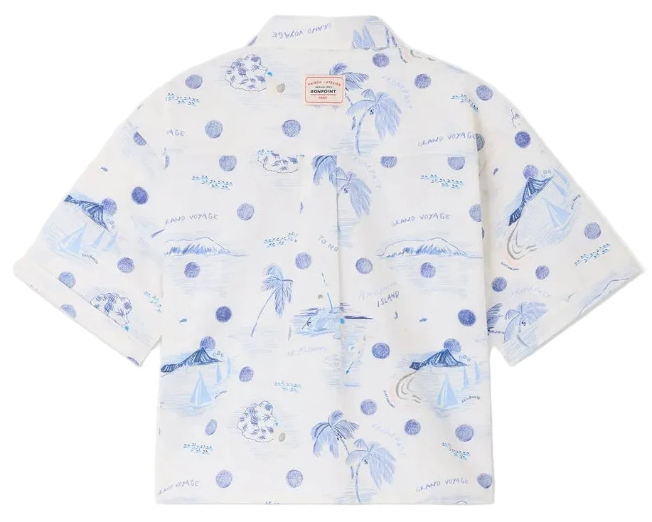 The Boys' Erian Shirt by Bonpoint is a short-sleeved, button-up shirt for boys, made from organic cotton with a white base and blue island-inspired prints featuring palm trees, sailboats, water, and handwritten phrases.