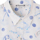 Close-up of the Boys' Erian Shirt by Bonpoint, featuring organic cotton fabric with blue island-inspired prints, white buttons, and a visible brand label inside the collar.
