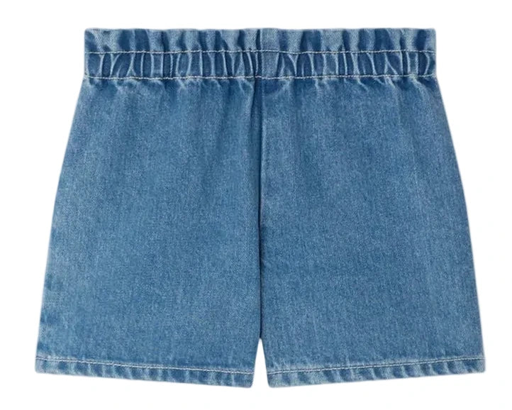 Bonpoint Girls' Milly Shorts in blue denim with an elastic waist and cherry embroidery, shown laid flat on a white background.