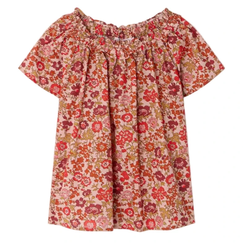 The Bonpoint Girls' Goldia blouse in Liberty Fabric features short sleeves, a pink, red, and orange floral pattern, soft organic cotton material, and a gathered elasticated neckline.