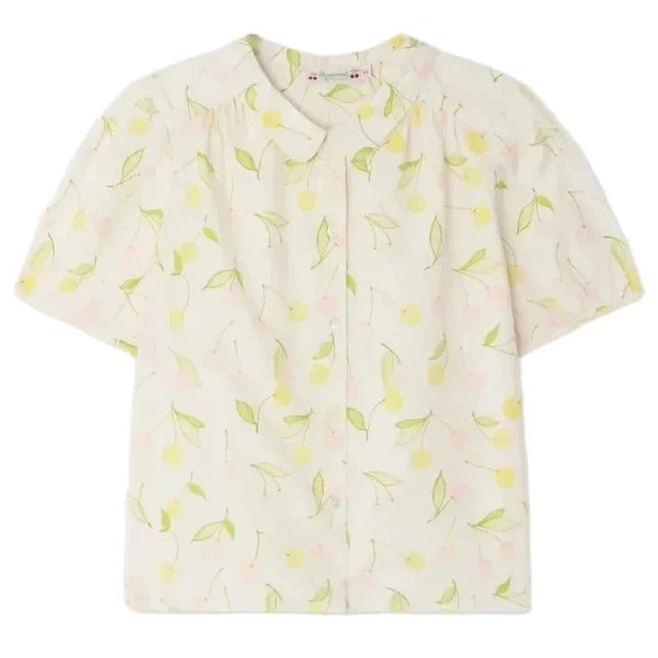 The Bonpoint Girls' Adèle Blouse is a light-colored, short-sleeve top with a lemon and leaf print, rounded collar, and button-down front.