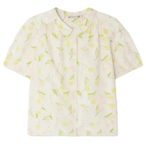 The Bonpoint Girls' Adèle Blouse is a light-colored, short-sleeve top with a lemon and leaf print, rounded collar, and button-down front.