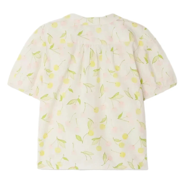 The Bonpoint Girls' Adèle Blouse is a short-sleeved, light-colored top featuring a yellow and green cherry and leaf print, shown from the back.