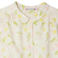 Close-up of Bonpoint's Girls' Adèle Blouse—crafted from light organic cotton, this blouse features a round collar, button front, and a cheerful cherry print in yellow and pink with green stems and leaves.