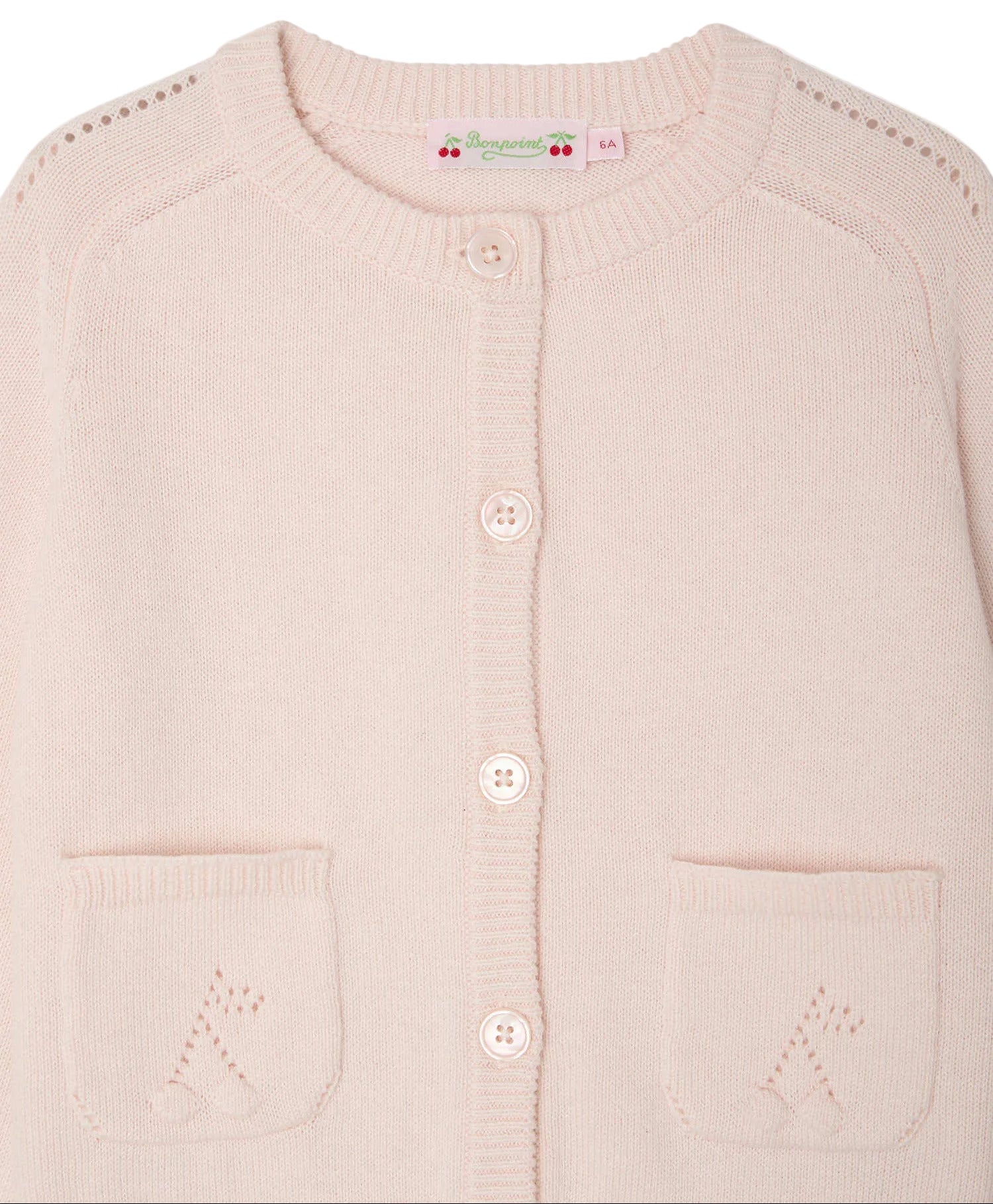 The Bonpoint Girls' Elisea Round Neck Cardigan in Organic Cotton is light pink with two front pockets, a button-down front, and openwork knit details on the shoulders and pockets.