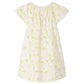 The Bonpoint Girls' Smocked Salomé Dress is a light-colored, short-sleeve organic cotton dress with a loose fit and a charming green leaf and yellow flower pattern.