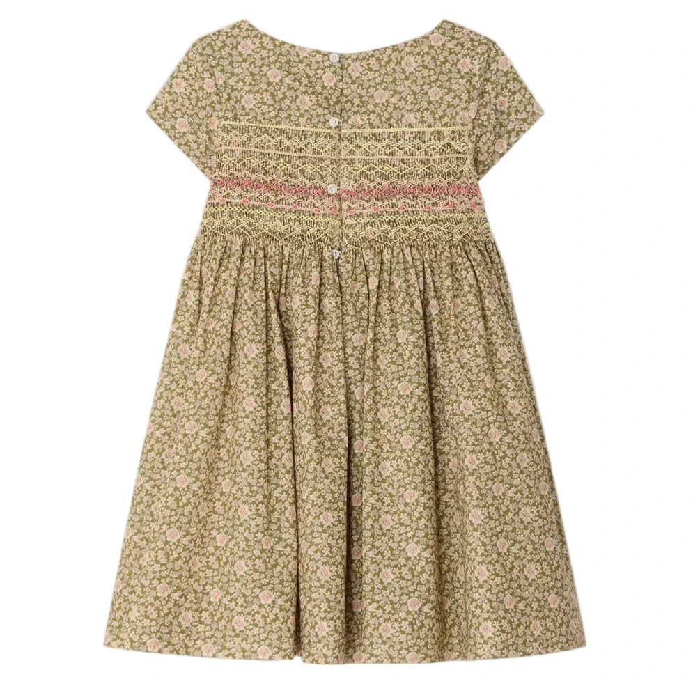 The Bonpoint Girls' Duchesse Smocked Dress features short sleeves, a knee-length gathered skirt, Liberty green and pink floral fabric, a hand-embroidered smocked bodice, and back buttons.