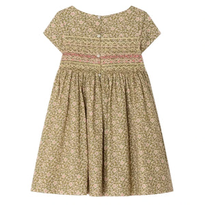 The Bonpoint Girls' Duchesse Smocked Dress features short sleeves, a knee-length gathered skirt, Liberty green and pink floral fabric, a hand-embroidered smocked bodice, and back buttons.